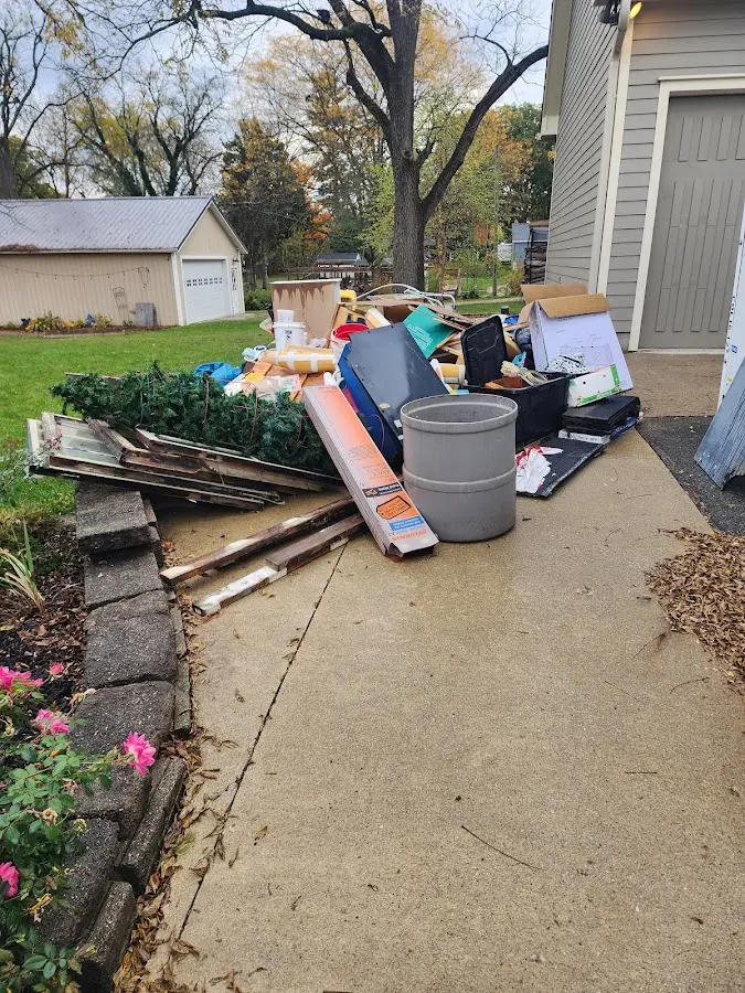 Dumpster being loaded with debris for Estate Cleanout Dumpster Rental in South Daytona